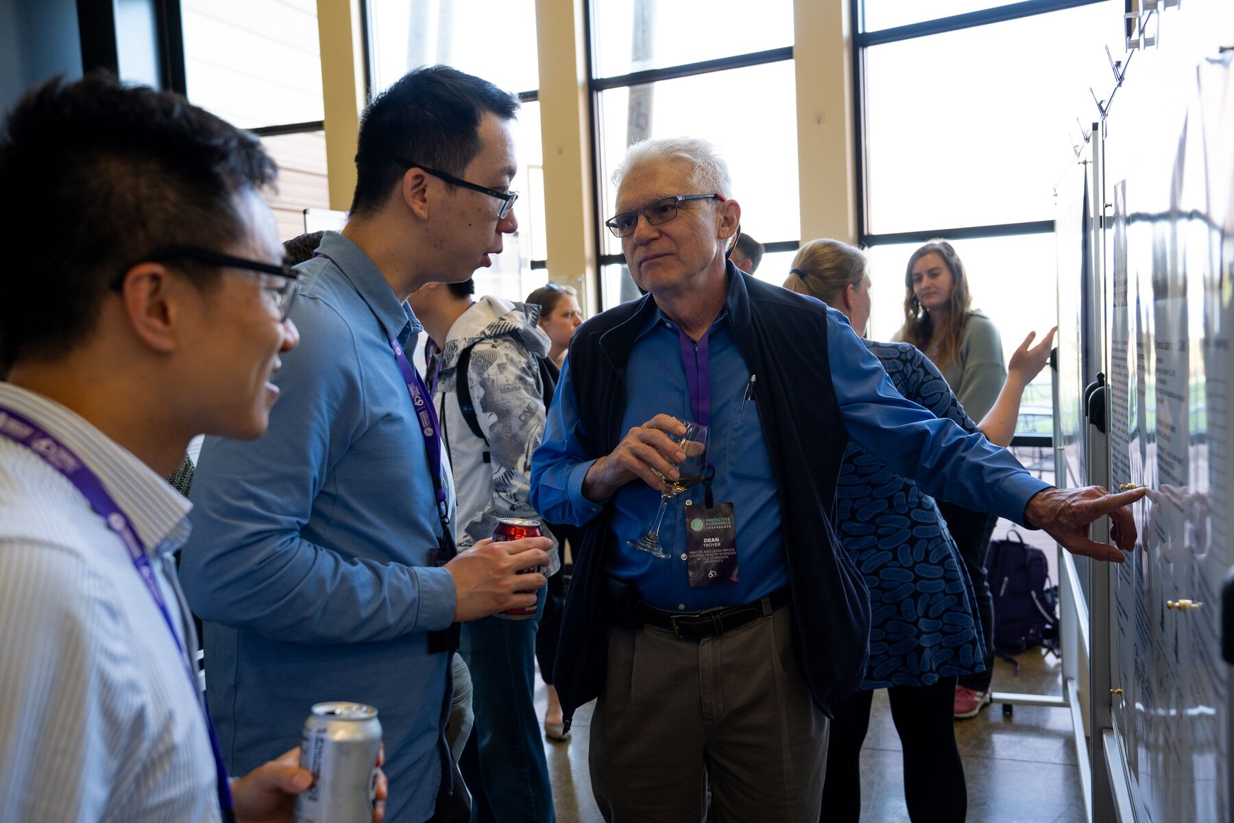 Drs. Peng Gao, Harvard T.H. Chan School of Public Health (middle) and Donghai Liang, Emory University’s Rollins School of Public Health (left) chat with attendee Dean Troyer at the poster session of the Predictive Phenomics Conference. Photo by Andrea Starr | Pacific Northwest National Laboratory.
